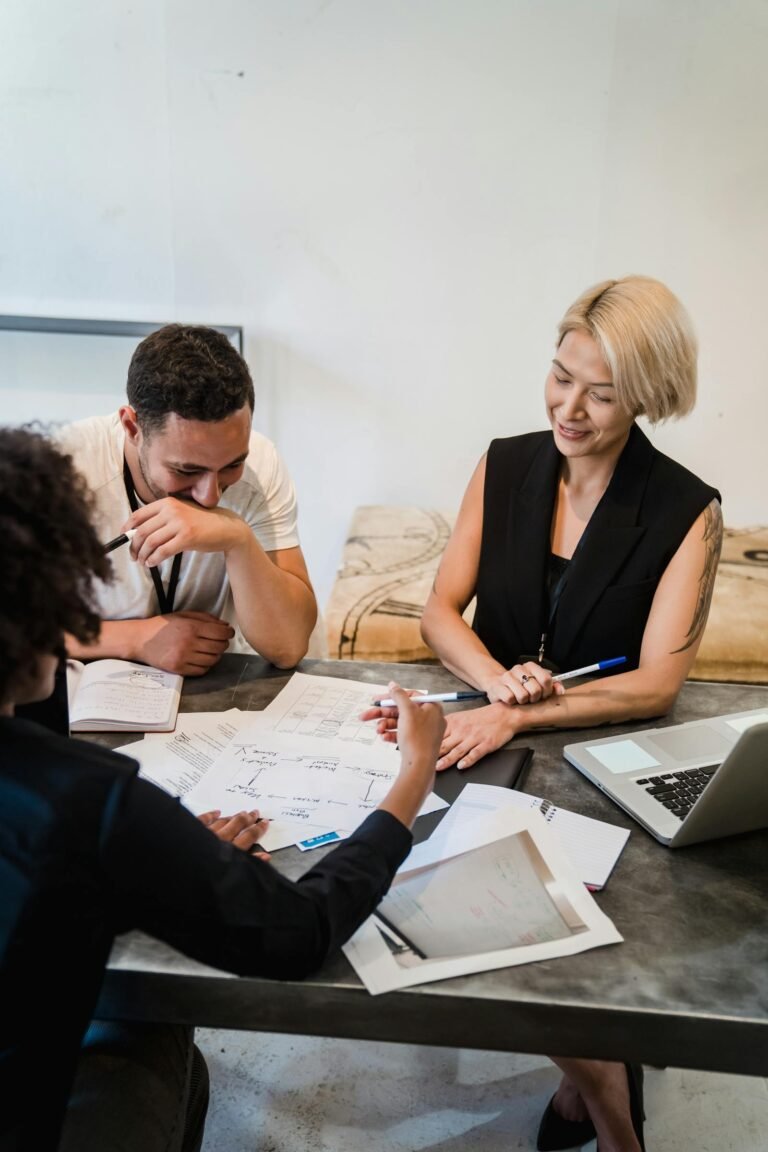 Business and technology team planning roles around a meeting table